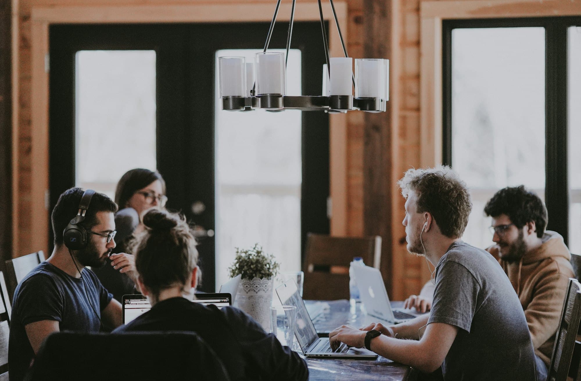 A leadership team gathered around a table in conversation
