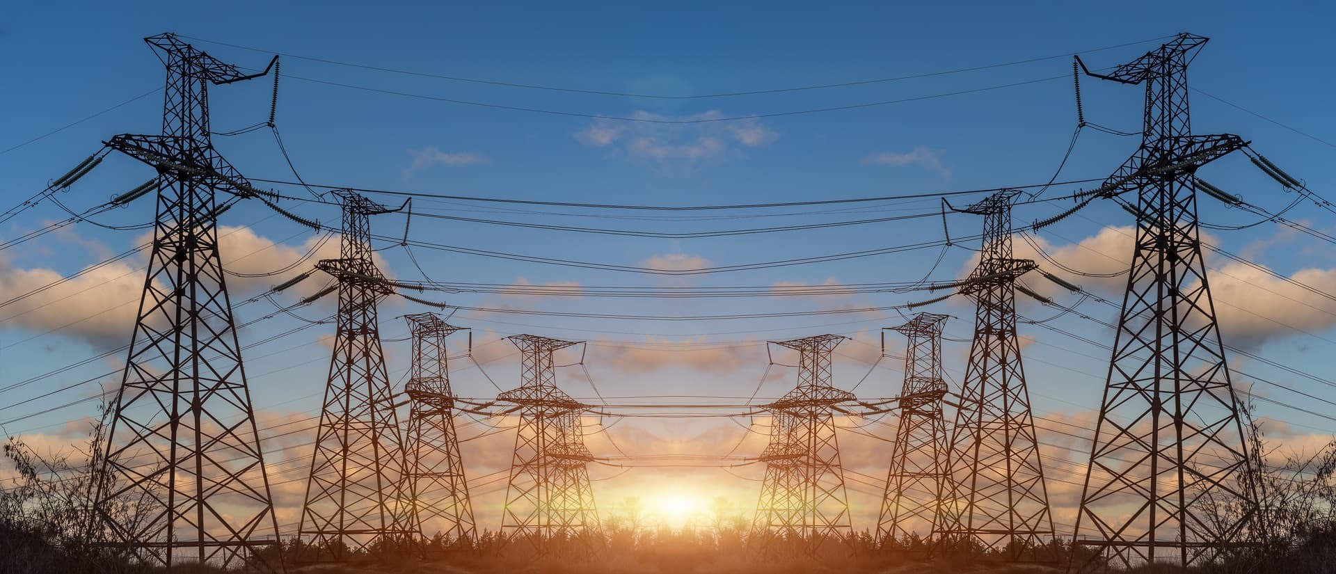 High-voltage electricity transmission towers against the sky