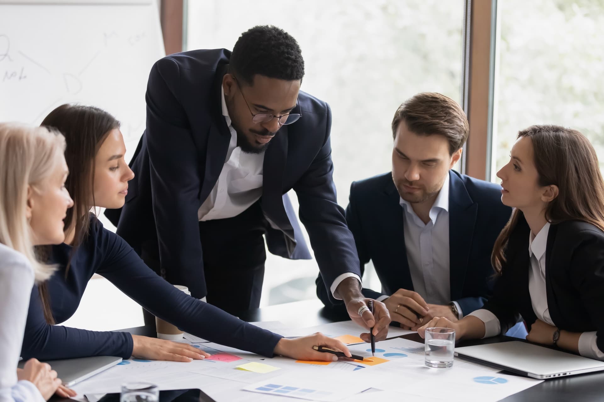 A team working together around a laptop