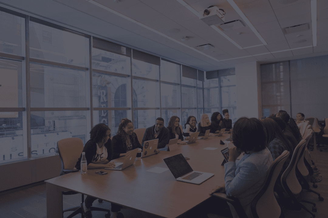 Participants seated around a boardroom table in a working session