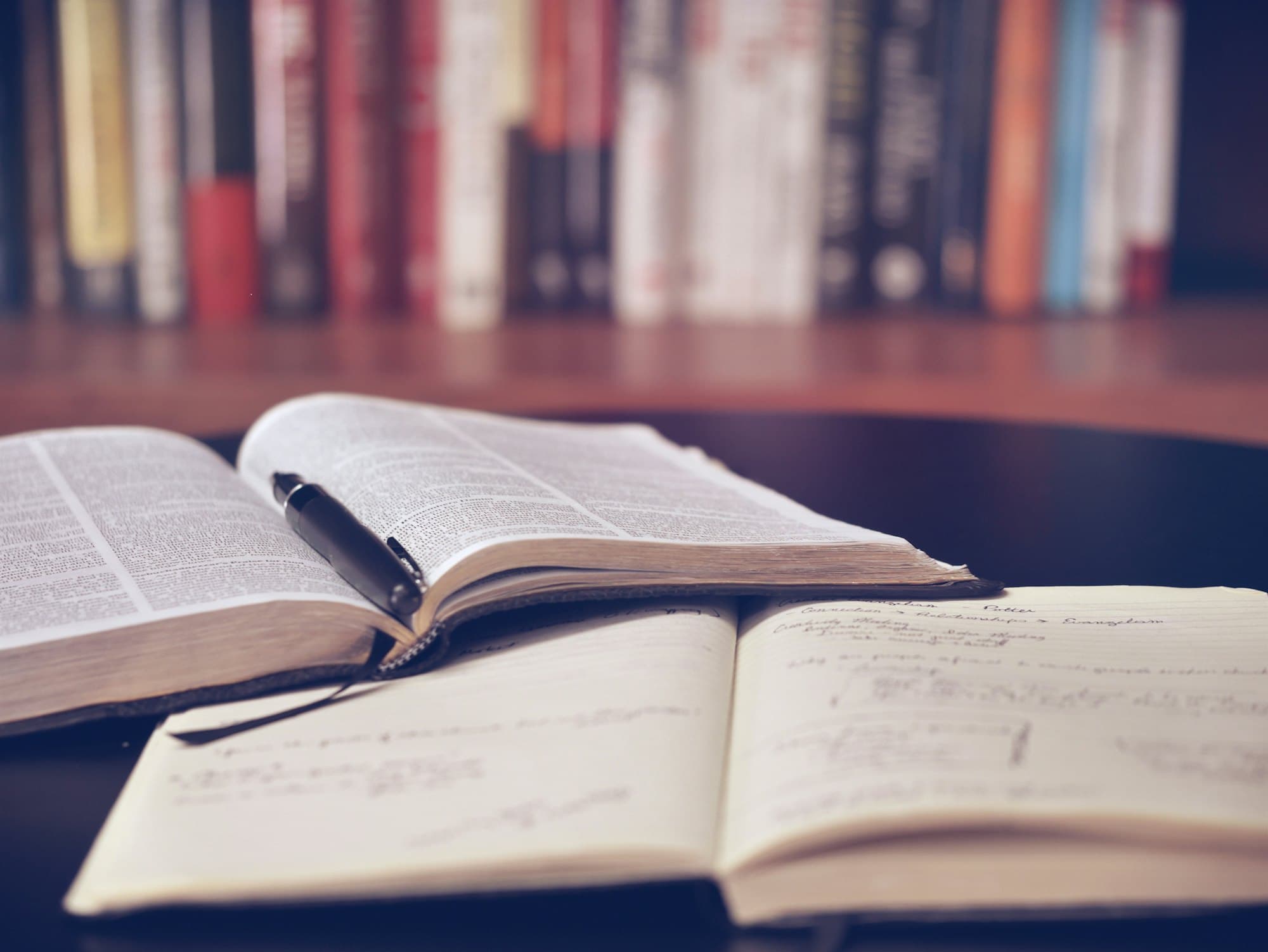 An open notebook and pen on a desk, ready for ideas